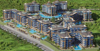 A complex in a picturesque area with a sea view